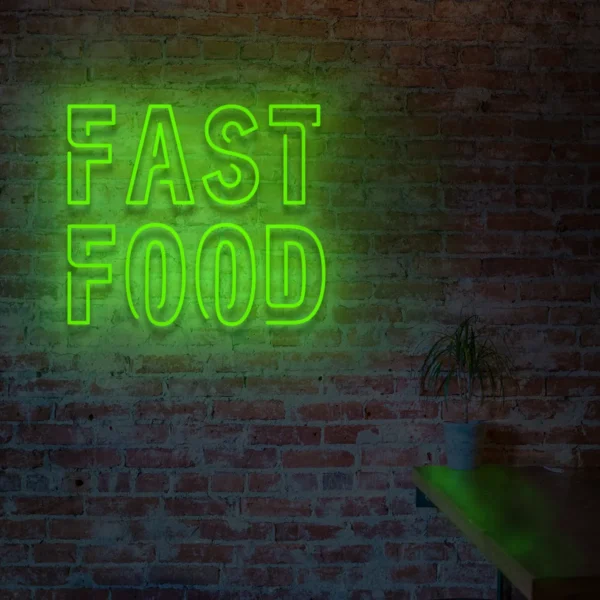 Zielony neonowy napis Fast Food świecący na ścianie