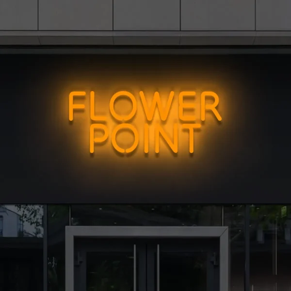 Pomarańczowy neon LED Flower Point – energetyczny napis świetlny na fasadzie