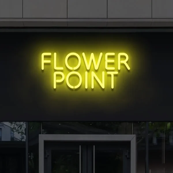 Żółty neon Flower Point – jasny napis LED na czarnej elewacji